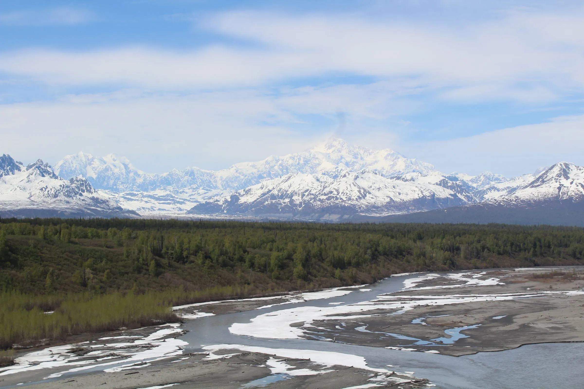 Snow-covered mountains and a braided river in Denali National Park