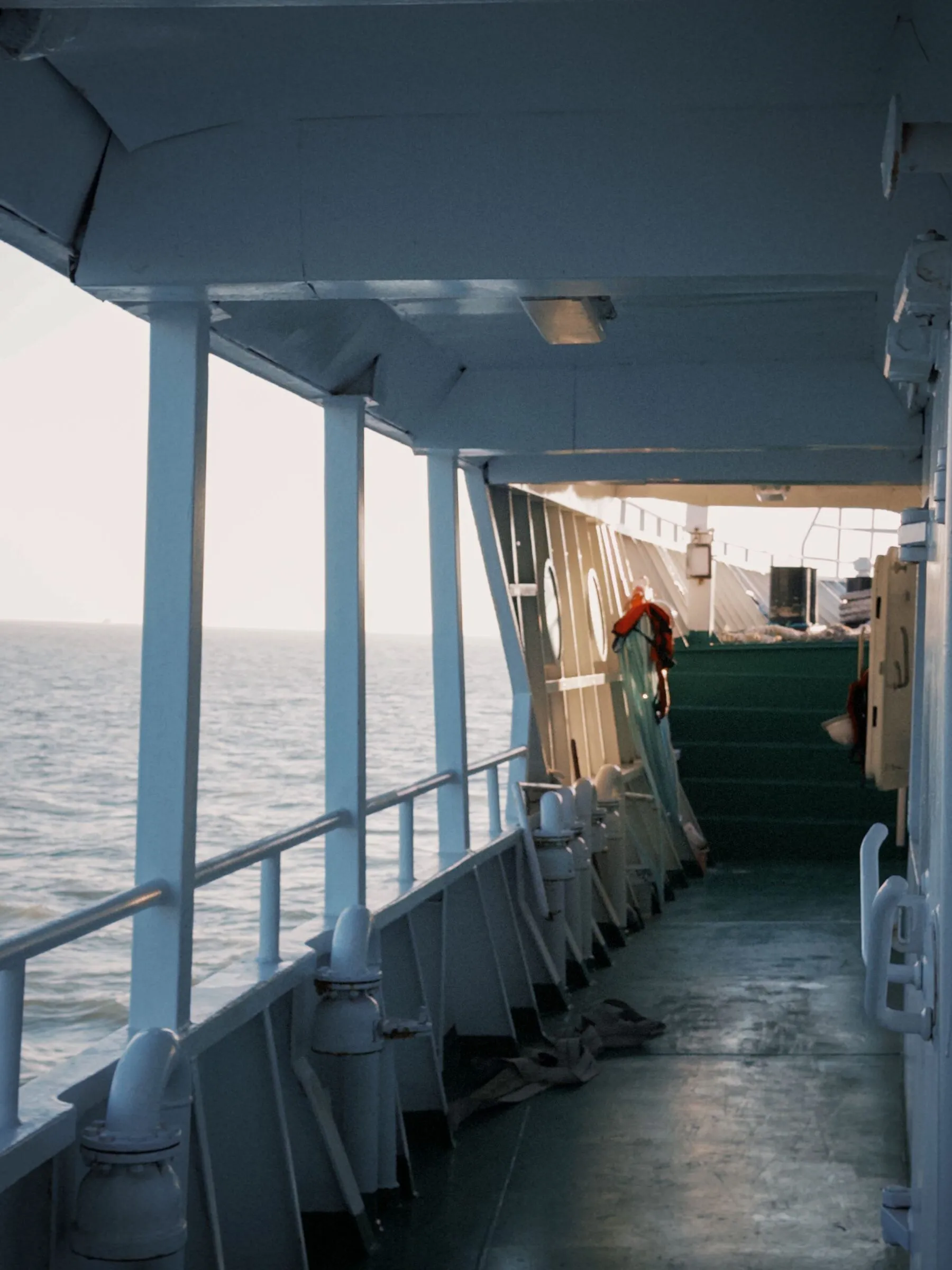 A quiet ship deck opening toward the ocean