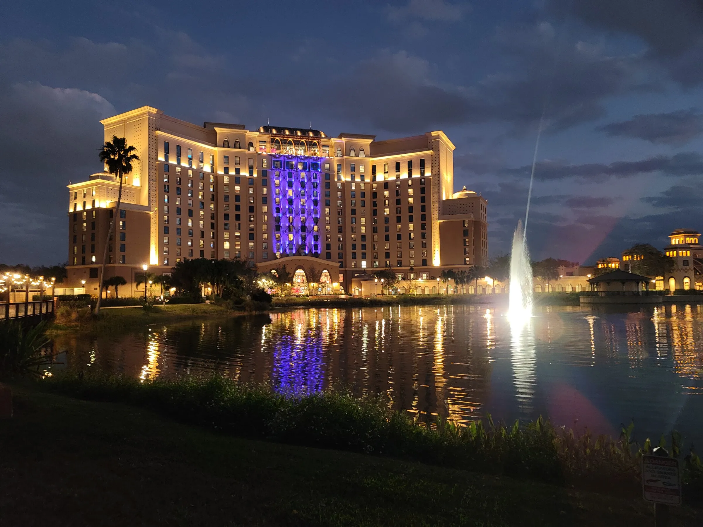 A Central Florida resort reflected in a waterfront lagoon at blue hour