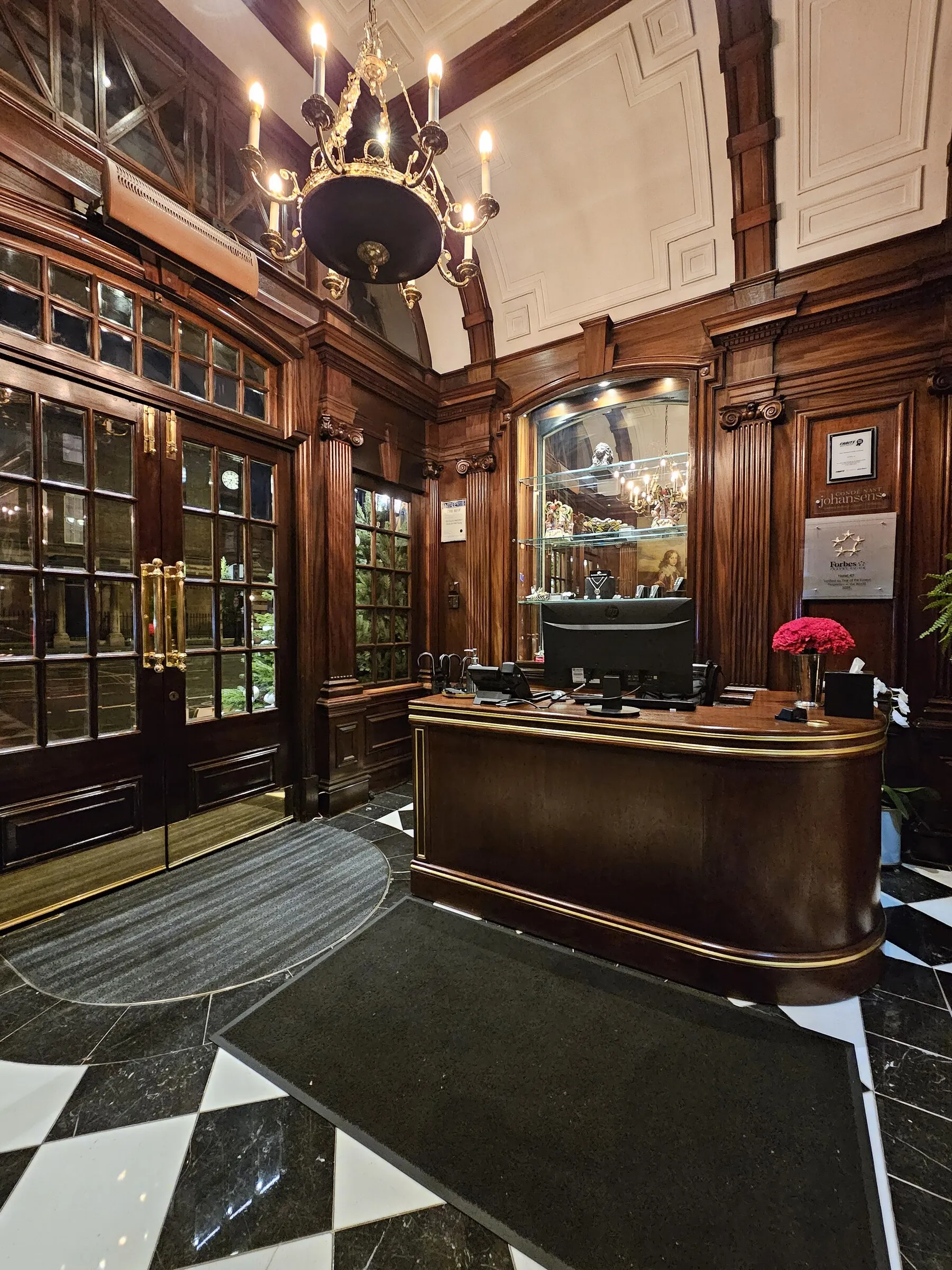 The warm, wood-paneled reception desk at Hotel 41 in London
