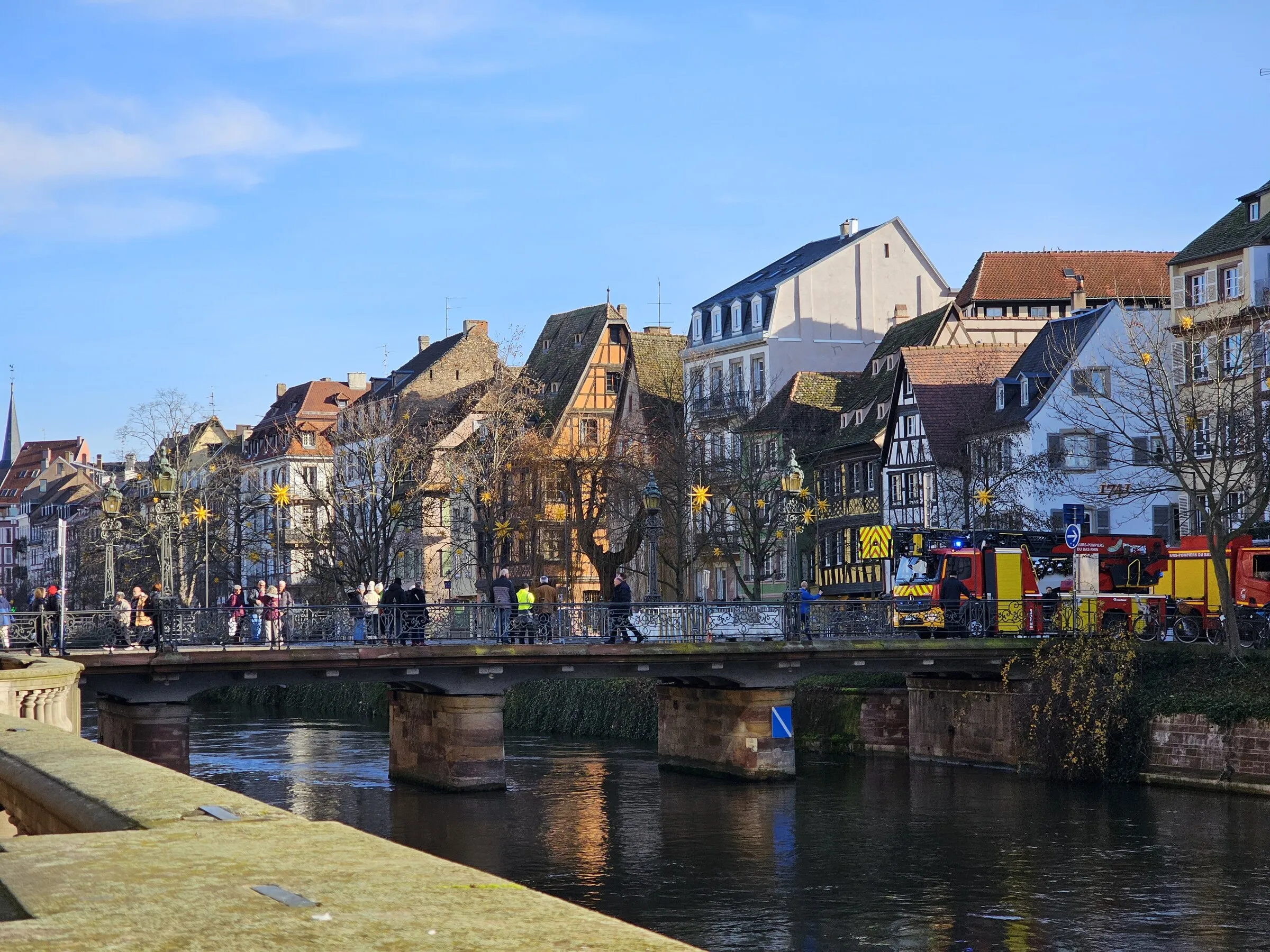 Historic buildings reflected along a canal in Strasbourg